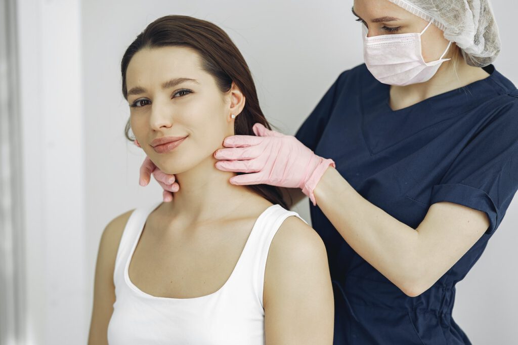 Doctor is checking her patient's neck