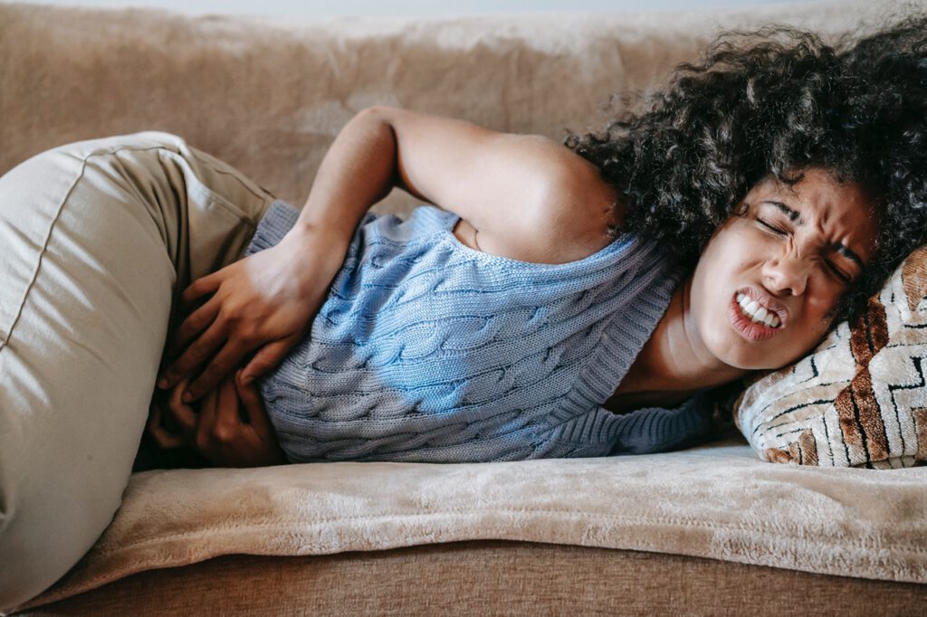 Woman on the sofa in pain